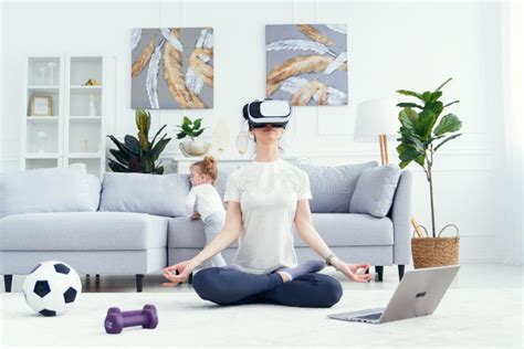 Young Sports Woman Practising Yoga Using Vr Technology Headset At