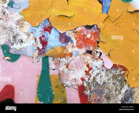 Layers Of Coloured Paint Peeling Off A Concrete Wall Forming An