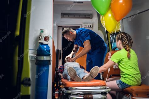 Premium Photo A Paramedic In A Blue Medical Uniform Regulates An