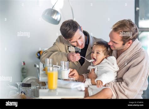 Gay Couple Feeding Son Breakfast Stock Photo Alamy