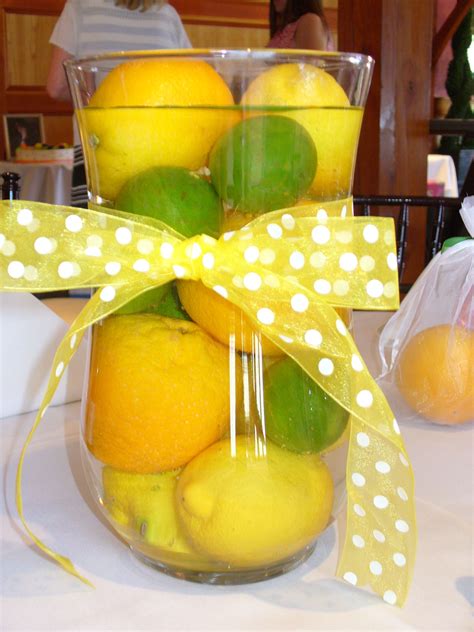 Lemons Limes And Oranges In A Vase With Water And A Bow Make The