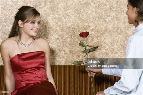 Teenage Boy Giving Teenage Girl Rose Stock Photo - Download Image Now ...