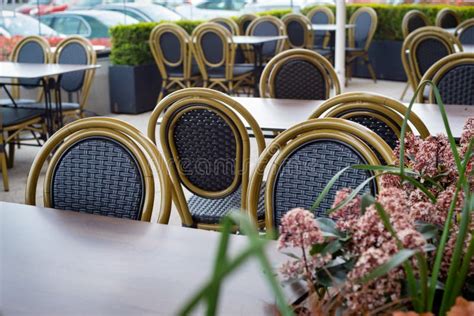 Clean Empty Tables And Chairs At Outdoor Cafe Restaurant Surrounded By