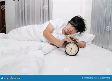 Hands Of Sleepless And Desperate Young Man Turns Off The Alarm Clock