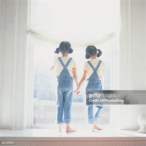 Twin Girls Holding Hands Photos And Premium High Res Pictures Getty