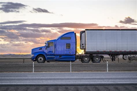 Side View Of The Blue Classic Bonnet Big Rig Semi Truck With Extended