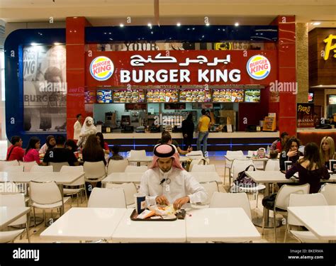 An Arabic Man Eating A Burger From Burger King In Dubai Stock Photo Alamy