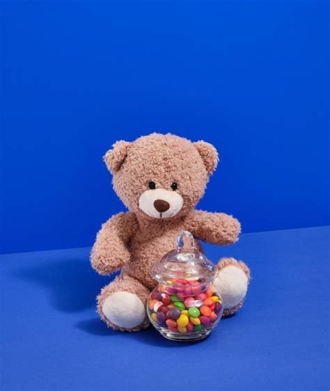 Premium Photo | A soft cute teddy bear and delicious sweets toys for babies