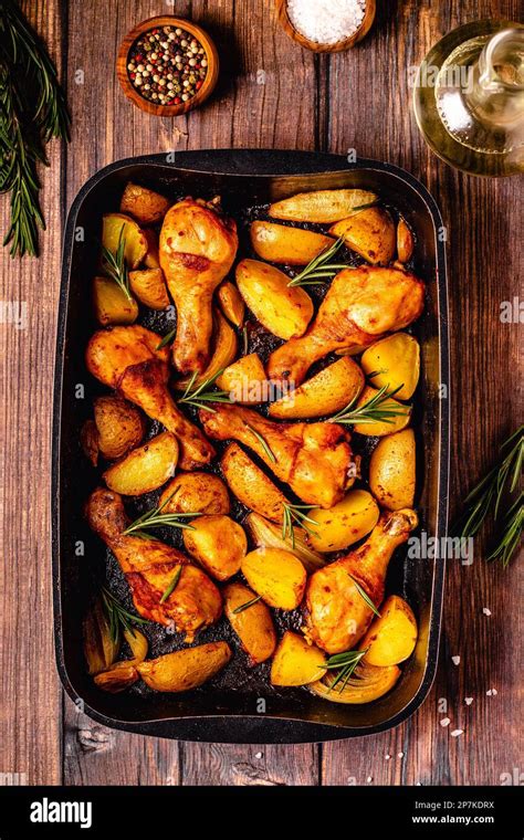 Roasted Chicken Legs With Potatoes And Rosemary Top View Stock Photo