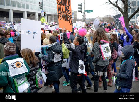 Large Crowd Of Protesters Holding Signs And Some Wearing Pink Pussy Hats Flood The In Washington