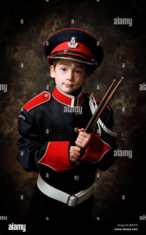 boy in a marching band uniform holding drum sticks Stock Photo - Alamy