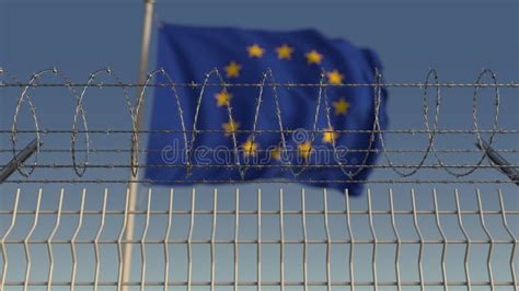 Defocused Waving Flag Of The European Union Eu Behind Barbed Wire Fence