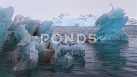 Iceberg crystalline shapes, awesome colors, floating on Arctic ocean ...