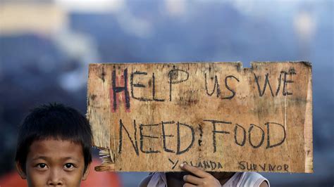 Typhoon Survivors Reach Out For Food In Tacloban