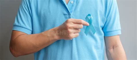 November Prostate Cancer Awareness Month Man In Blue Shirt With Hand