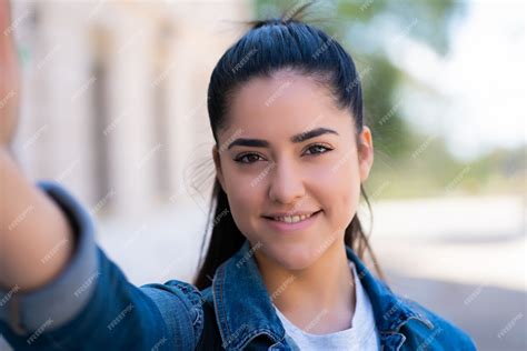 Free Photo Portrait Of Young Woman Taking Selfies While Standing