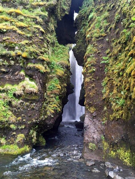 Premium Photo Waterfall Seen Through Rock Formation In Forest