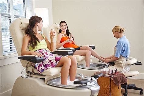 Girlfriends Getting Pedicure At Nail Salon Spa By Stocksy Contributor