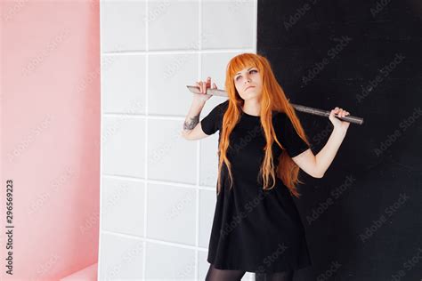 Woman cosplayer anime with red hair holds a Japanese sword Stock Photo ...