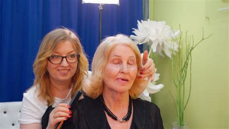 Hairstylist Doing Hairstyle For Blond Mature Woman In Beauty Salon Beauty Stylist Hairstyling