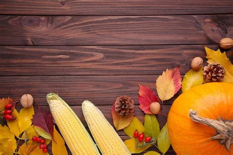 Premium Photo Orange Pumpkin With Leaves And Vegetables On Brown