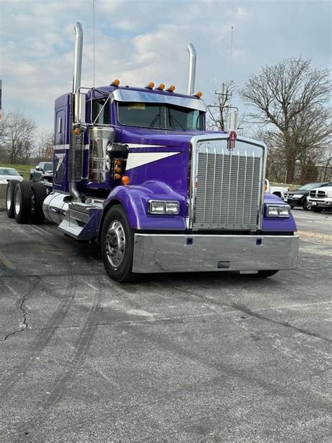 A Purple Semi Truck Parked In A Parking Lot