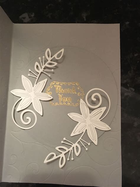 a card with some flowers and leaves on it