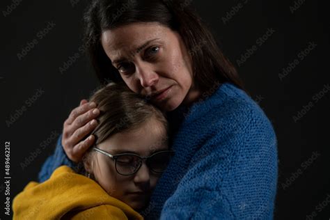 Mother And Daughter Hugging Sad