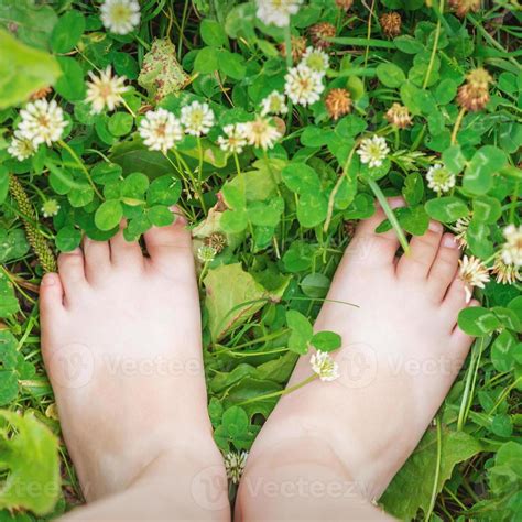 Baby feet barefoot on green grass 13187143 Stock Photo at Vecteezy