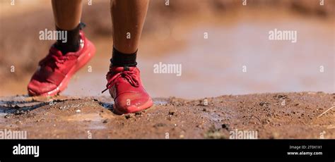 Mud Race Runners Overcoming A Water Obstacle During Extreme Obstacle