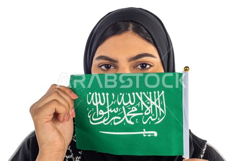 Portrait Of A Saudi Arabian Gulf Woman Holding The Flag Of The Kingdom