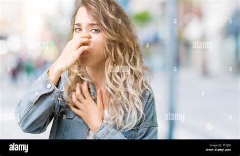 Beautiful Young Blonde Woman Wearing Denim Jacket Over Isolated