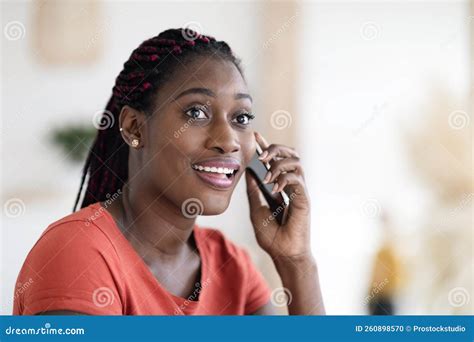 Portrait Of Beautiful Smiling Black Woman Talking On Mobile Phone At