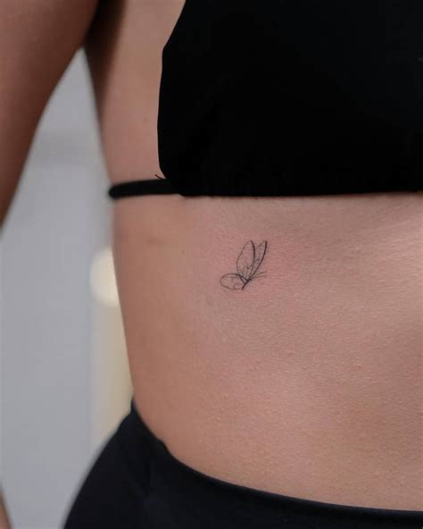 Fine Line Style Butterfly Tattoo Located On The Rib