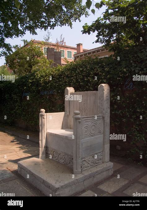 Carved stone chair in the outside garden of the Peggy Guggenheim Collection in the Dorsoduro ...