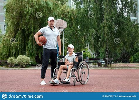 Dad Plays With His Disabled Son On The Sports Ground Concept