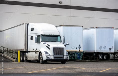 Big Rig White Semi Truck With Dry Van Semi Trailer Loading Cargo In