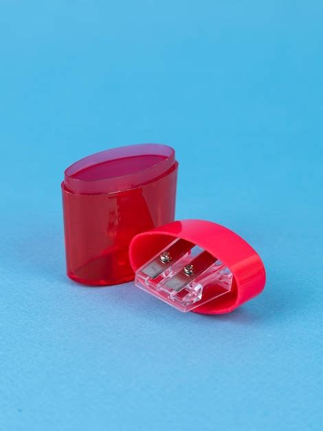 Premium Photo | Red pencil sharpener isolated on blue background