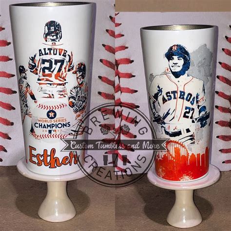 Two Baseball Themed Cups Sitting On Top Of A Table