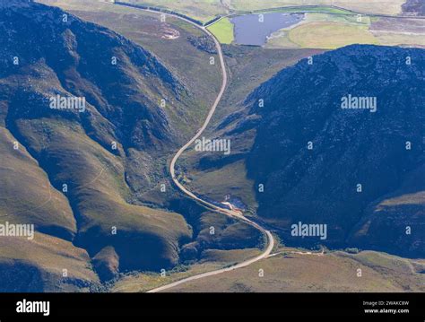 Aerial photograph of a winding road crossing the Cape Fold Mountains ...