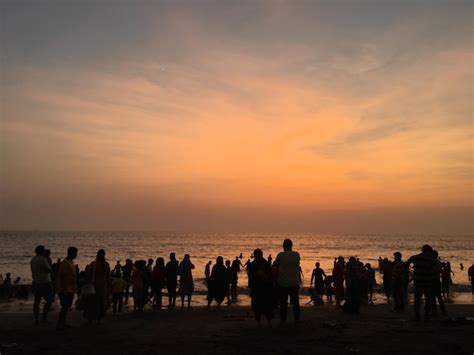 Premium Photo | Silhouette crowd at beach during sunset