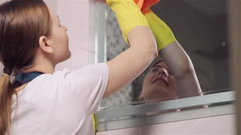 Housework Cleaning Mirrors With A Rag For Cleaning Reflection In The