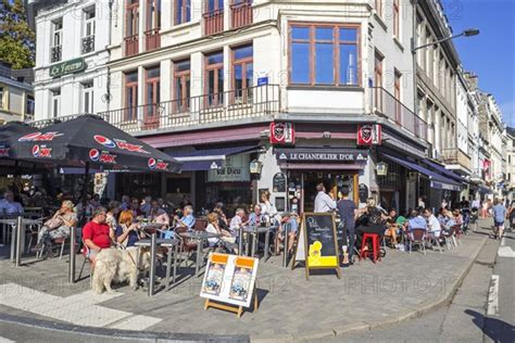 Tourists Enjoying Belgian Beer On Pavement Cafe In Summer In The City