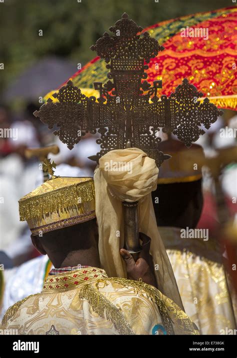 Ethiopian Orthodox Priest Holding A Cross During The Colorful Timkat