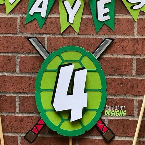 There Is A Cake Topper With The Number Four In Front Of A Brick Wall