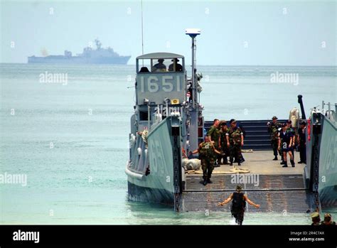 Us Navy With The Amphibious Dock Landing Ship Uss Harpers Ferry Lsd 49 In The Background