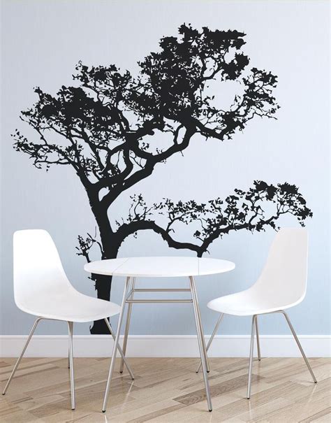 a black and white tree wall decal on a dining room table with two chairs