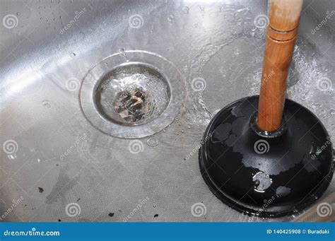 Plunger and kitchen sink stock photo. Image of clog - 140425908