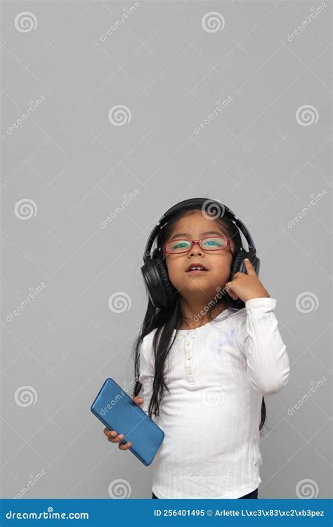 Year Old Brunette Latin Girl With Glasses Listens To Music In Her Headphones Connected To Her