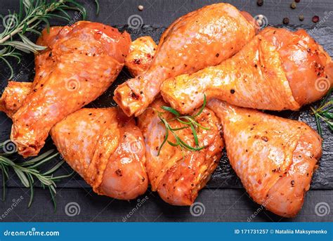 Chicken Legs In A Red Marinade On A Cooking Board Pickled Raw Meat